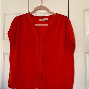 Capped sleeve blouse with red with orange hues